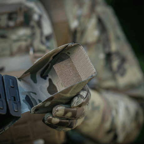 M-Tac Double Magazine Pouch with Fastex Closure used by a tactical operator in a field environment, camouflage pattern