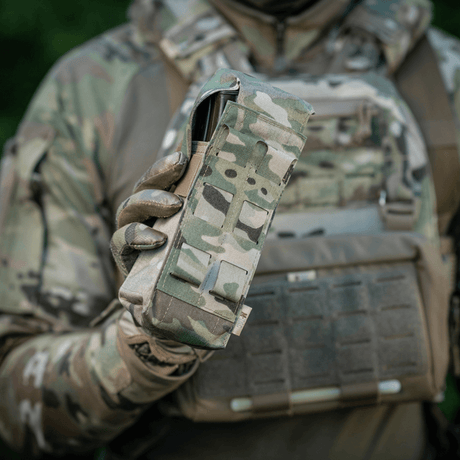 M-Tac Double Magazine Pouch with Fastex Closure in the hand of a uniformed person, designed for AR and AK series magazines