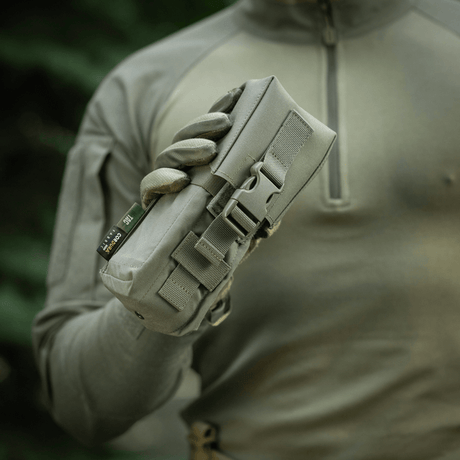 Soldier holding M-Tac Double Magazine Pouch with Fastex Closure in durable Cordura 500D material