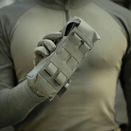 M-Tac Double Magazine Pouch with Fastex Closure held by man in military green clothing, designed for AR and AK series magazines
