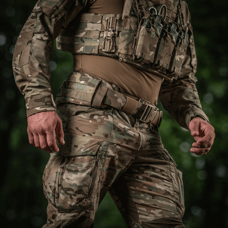 A soldier wearing M-Tac War Belt ARMOR with MOLLE webbing and a secure closure, ideal for tactical use in combat situations.