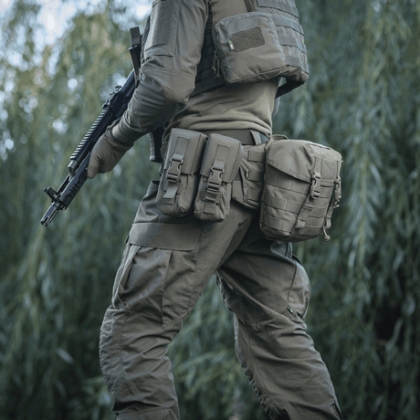 M-Tac War Belt ARMOR in use with MOLLE-webbing for field combat in outdoor environments.