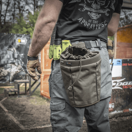 A person wearing an M-Tac Mag Drop Pouch Elite mounted on gear with MOLLE attachments for quick access to magazines