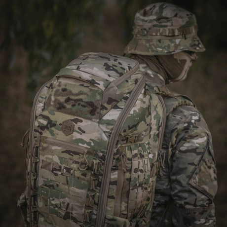 M-Tac Large Gen.IV Elite in camo used outdoors, made of durable Cordura for durability.