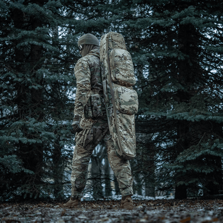 Person in forest with M-Tac Gun Backpack Case 125 cm Gen.II Elite, designed for safe weapon transport, camouflage