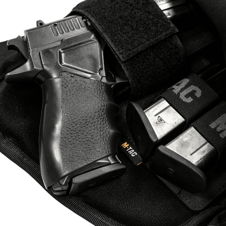 M-Tac Double Mag Pouch Hook Backed Magazine with a pistol and magazines in a Velcro-secured pouch.