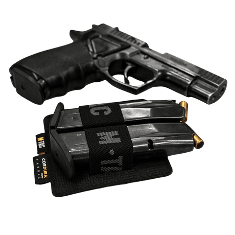 M-Tac Double Mag Pouch Hook Backed Magazine with two magazines next to a pistol on a black background