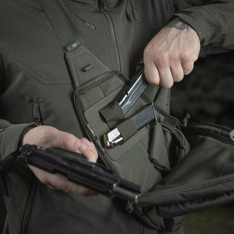 Person using M-Tac Double Mag Pouch Hook Backed Magazine for pistol magazine storage in a tactical bag