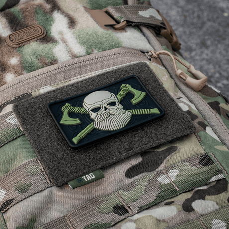 M-Tac Tactical Morale Patch Display Board Hook and Loop Molle 120x85 mounted on a camouflage bag with a skull patch.