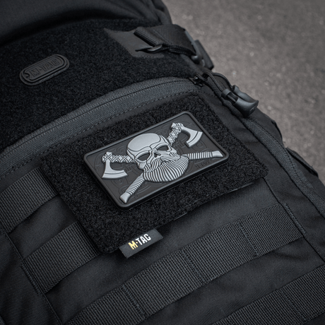 M-Tac Tactical Morale Patch Display Board Hook and Loop Molle 120x85 mounted on a black bag with a plastic base for stability.