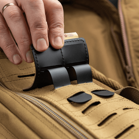 M-Tac MOLLE patch panel 80x85 mm attached to a bag with hook & loop system, plastic base and MOLLE compatibility.