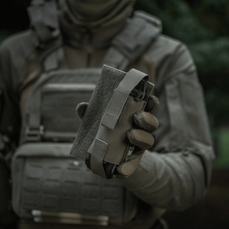 M-Tac Tourniquet Pouch Elastic VELCRO Gen.II held by a person in tactical gear for quick access to a tourniquet