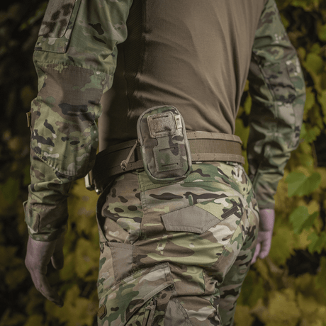 M-Tac PC Utility Pouch Elite mounted on a belt, MOLLE system, camouflage background, made of durable 500D Cordura. Perfect for tactical use