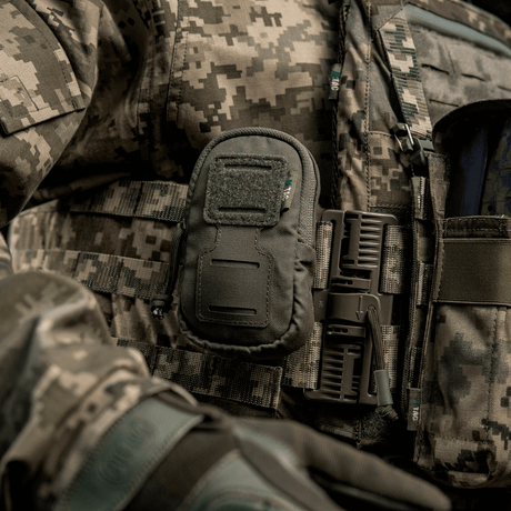 M-Tac PC Utility Pouch Elite mounted on a tactical vest with MOLLE interface and Velcro panel, ideal for storage and with a bottom drain