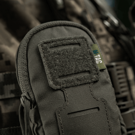 M-Tac PC Utility Pouch Elite with MOLLE interface and Velcro panel, 500D Cordura, close-up on camouflage background.