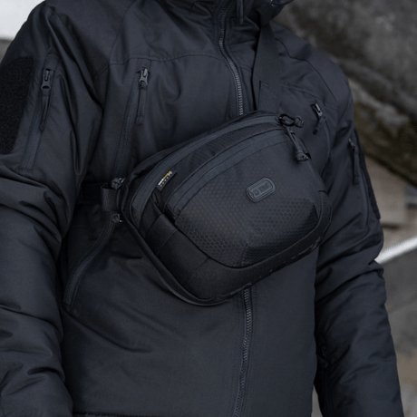 M-Tac Sphaera Hex Hardsling Bag worn as shoulder bag. Compact Cordura/Hex polyester design with modular system and hidden weapon compartment.