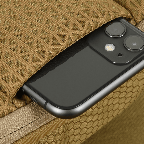 M-Tac Sphaera Hex Hardsling Bag Gen.II Elite with a pocket showing a smartphone partially inside the bag.