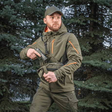 Man wearing M-Tac Sphaera Hex Hardsling Bag Gen.II Elite in the woods, positioned for quick access with concealed carry system.