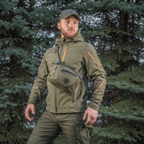 Man wearing M-Tac Sphaera Hex Hardsling Bag Gen.II Elite in a woodland area.
