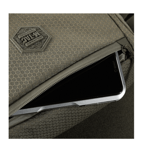 Detail of M-Tac Magnet XL Bag Elite Hex with FidLock locking system and Velcro panel, shown with smartphone storage.