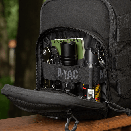 M‑Tac Cross Bag Elite Hex open compartment showing storage of tactical gear in black Cordura