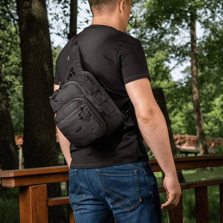 M-Tac Cross Bag Elite Hex worn as a one-shoulder sling by a man in a black t-shirt, for daily and tactical use