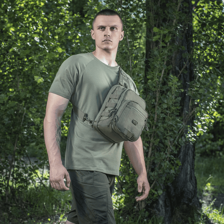 Man wearing M-Tac Cross Bag Elite Hex in a forest setting, suitable for daily use and tactical gear.