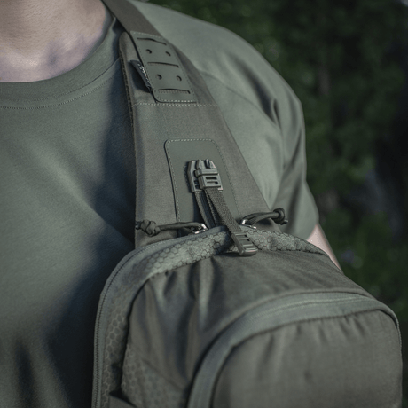 M-Tac Cross Bag Elite Hex sling pack worn on shoulder, perfect for daily use and tactical gear, military green color, Cordura fabric.