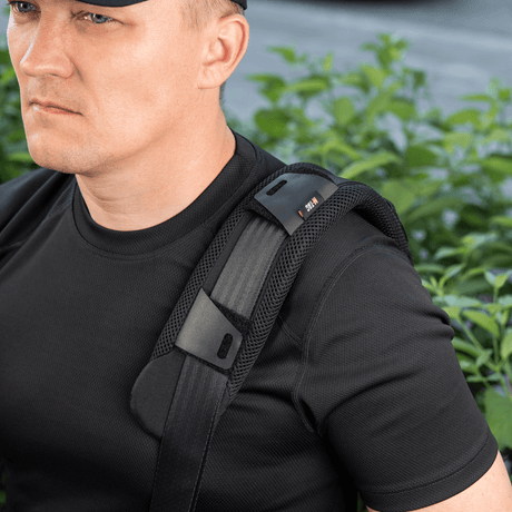 M-Tac Shoulder Strap Pad 50 mm Elite worn on a man's shoulder for comfort and weight distribution, made of Cordura and 3D mesh.