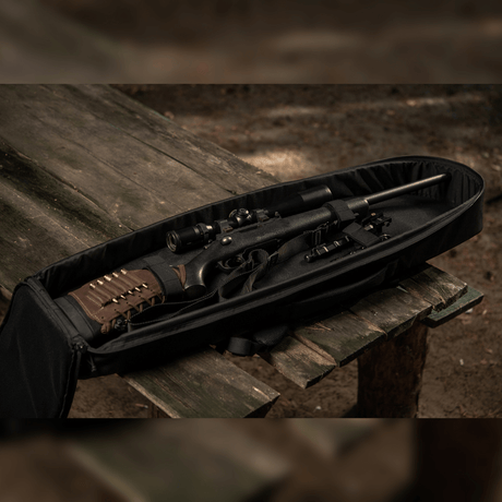 M-Tac Gun Backpack Case 105 cm Elite Hex with AR-15 disassembled on a table in the woods, showing internal compartmenting.
