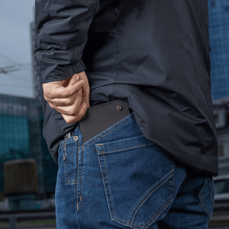 Person places M‑Tac Pung Slim Elite in back pocket of jeans.