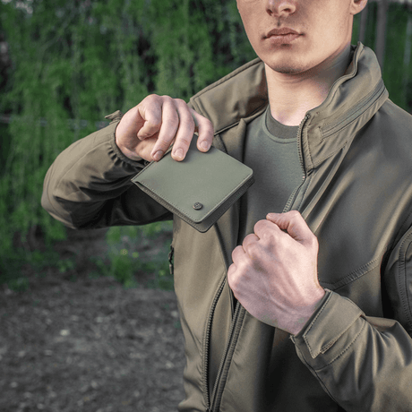 Man holds M-Tac Slim Elite Gen. II in a cap pocket, compact polymer composite design with card pockets and coin pocket.