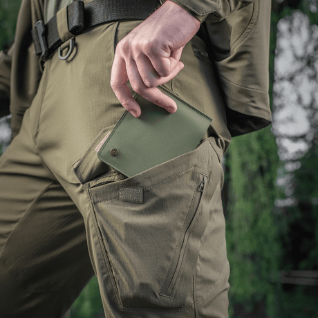M-Tac Slim Elite Gen. II in green, pulled out of a trouser pocket, showing compact design and modern production technology.