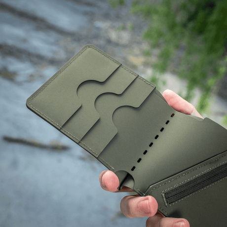 M-Tac Slim Elite Gen. II compact wallet with card pockets and coin pocket, held by a hand, made in durable polymer composite.