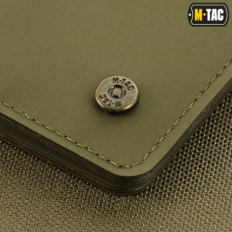 Close-up of M-Tac Slim Elite Gen. II with branded brass stud and compact design, made in durable polymer composite.