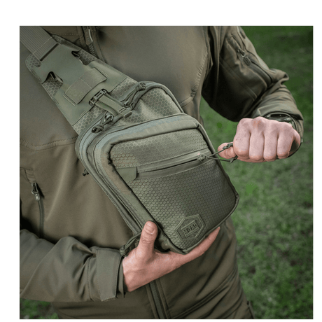 M-Tac Sling Pistol Bag Elite Hex in use, a comfortable, stylish bag with wear-resistant Cordura material and adjustable shoulder strap.