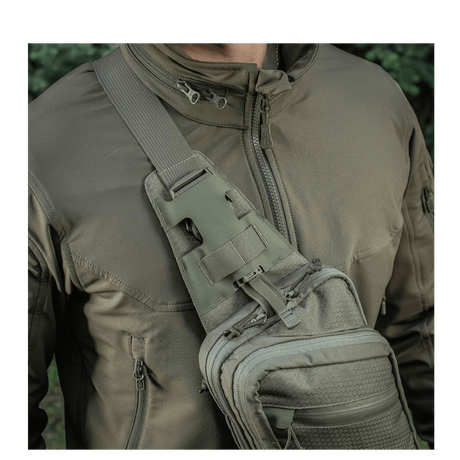 M-Tac Sling Pistol Bag Elite Hex in use, carried on the shoulder with adjustable strap and quick-release buckle, made of Cordura 1000D and Hex.