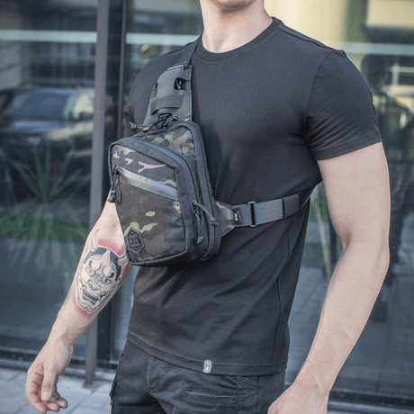 M-Tac Sling Pistol Bag Elite Hex worn by a man in a black t-shirt, showing bag details and adjustable shoulder strap.