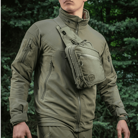 Man wearing M-Tac Sling Pistol Bag Elite Hex, a versatile, stylish bag for concealed weapons, made from Cordura 1000D.