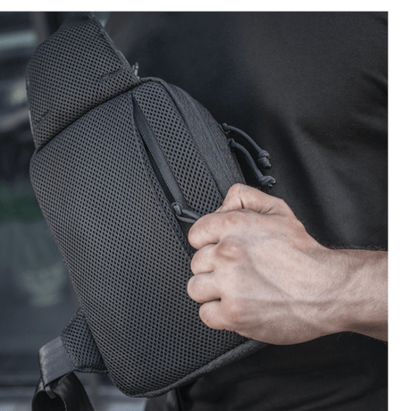 M-Tac Sling Pistol Bag Elite Hex in use with adjustable shoulder strap and roomy compartments, made from durable Cordura material.