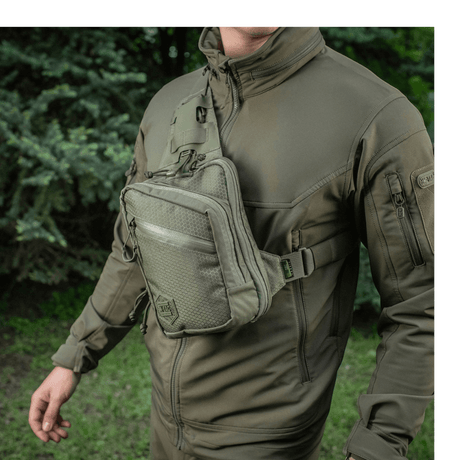 M-Tac Sling Pistol Bag Elite Hex worn by a person in nature.