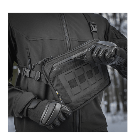 Person in black jacket demonstrating M-Tac Admin Bag Elite made from Cordura material with zippers and buckles