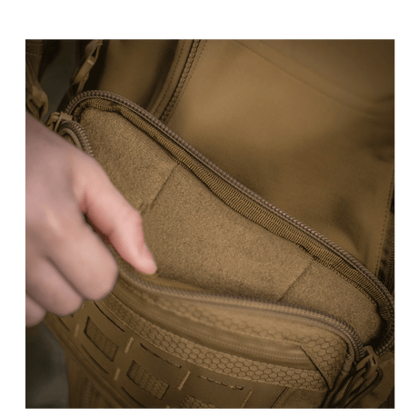 Person opening a pocket on M-Tac Admin Bag Elite made from Cordura material with YKK zippers