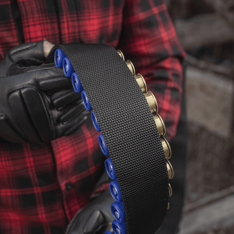 Person holding M-Tac Bandolier Elite, a cartridge bandolier with 55 shell slots, ideal for hunting and shooting sports.