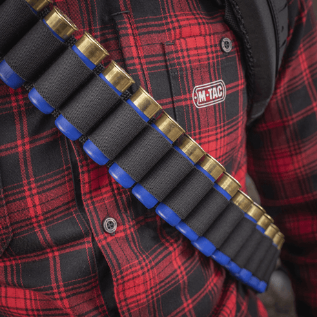 M-Tac Bandolier Elite cartridge bandolier for hunting and shooting sports with 55-shell capacity, worn over a red plaid shirt.
