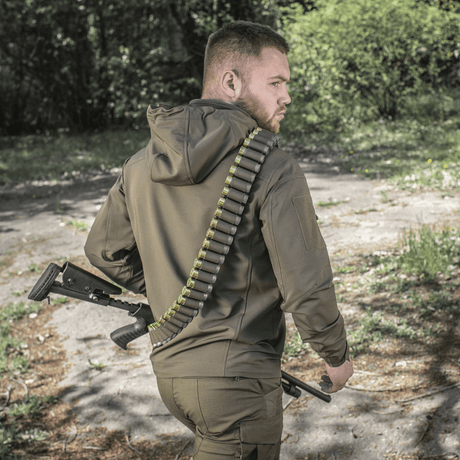 Hunter wearing M-Tac Bandolier Elite with ammunition in a forest environment.