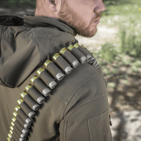 M-Tac Bandolier Elite worn by person, shows cartridge bandolier for hunting and shooting sports. Practical design, 55-shell capacity.