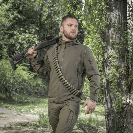 Hunter with M-Tac Bandolier Elite cartridge bandolier for 55 shells, designed for quick access to ammunition during hunting.