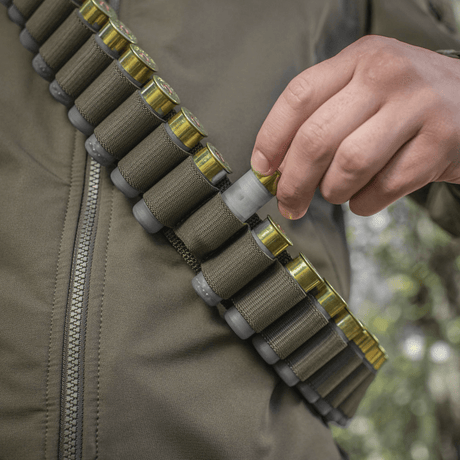 Person wearing M-Tac Bandolier Elite filled with ammunition for hunting and shooting sports.