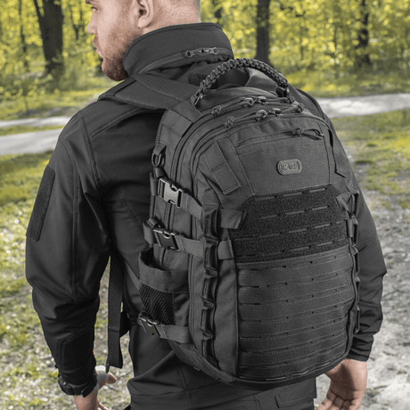 M-Tac Mission Pack Elite backpack with durable Cordura 1000D and MOLLE LASER CUT system in a forest setting.